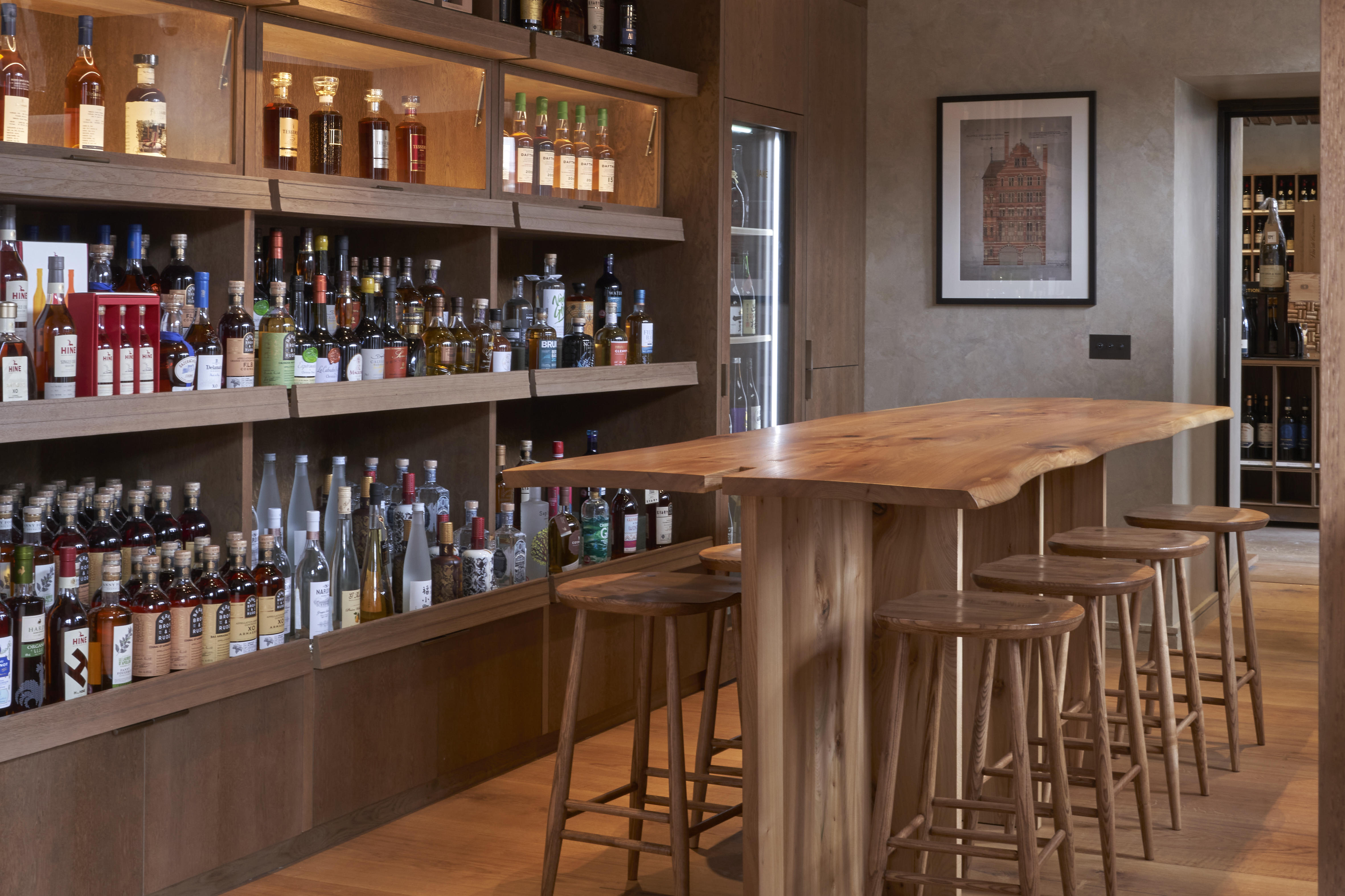 Six bottles of old and rare spirits against a blurred shop background. 